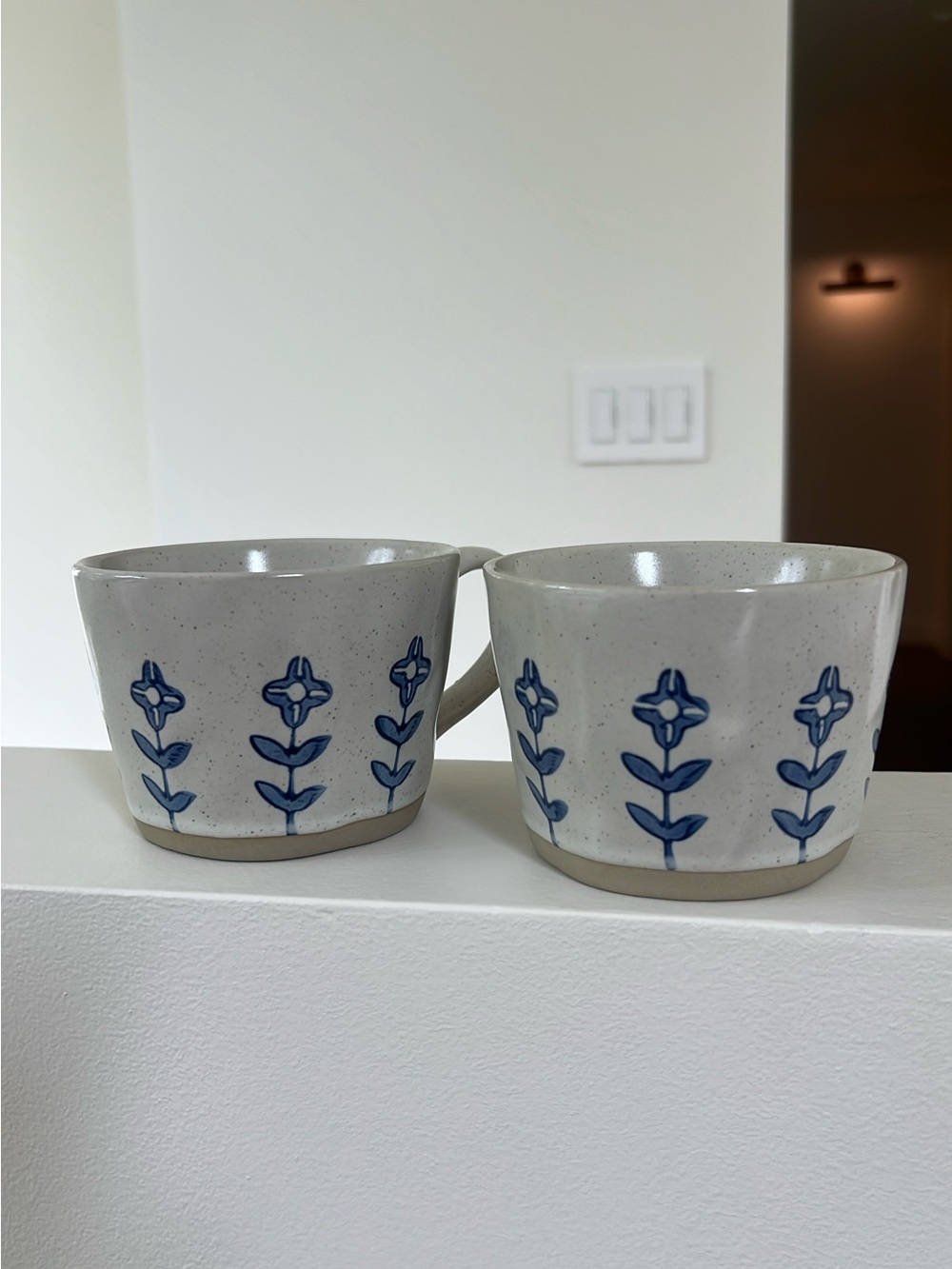 Speckled White Ceramic Mugs with Blue Floral Motif - Set of 2